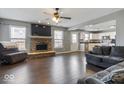 Spacious living room with hardwood floors, fireplace, and open kitchen at 9238 Bainbridge Dr, Camby, IN 46113