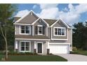 Charming two-story home with gray siding, a two-car garage, and a well-manicured lawn under a partly cloudy sky at 9965 Redwood Peak Ln, Indianapolis, IN 46259