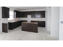 Dark brown kitchen cabinets, center island, and an open floor plan at 9965 Redwood Peak Ln, Indianapolis, IN 46259