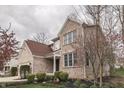 Charming two-story home with brick and siding, complemented by landscaped yard and blooming trees at 10402 Shakamak Way, Indianapolis, IN 46239