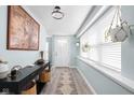 Inviting entryway with light blue walls, wooden floors, and bright natural light at 1102 N Newman St, Indianapolis, IN 46201