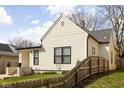 Charming home with black trim windows, fresh lawn, and wooden fence at 1102 N Newman St, Indianapolis, IN 46201