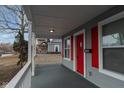 Front porch with red door and white railing at 1130 W 33Rd St, Indianapolis, IN 46208