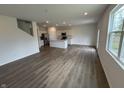 Open-concept living area featuring modern flooring, recessed lighting, and seamless transition to the kitchen at 116 Marble Wood Dr, Danville, IN 46122
