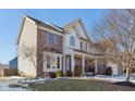 Attractive two-story home with brick and vinyl siding, complemented by manicured landscaping and a spacious front yard at 14928 Declaration Dr, Westfield, IN 46074