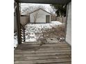 Wooden deck overlooks backyard with detached garage and snowy ground at 243 E Caven St, Indianapolis, IN 46225