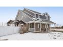 Two-story house with gray siding, covered porch, and a white fence at 5371 Lue Ann Ln, Mooresville, IN 46158