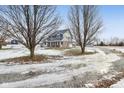 Two-story house on a snowy, tree-lined property with a long driveway at 5371 Lue Ann Ln, Mooresville, IN 46158