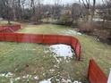 Large backyard with a red wooden fence and a small pile of snow at 5619 Pappas Dr, Indianapolis, IN 46237
