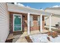 Covered front porch with brick columns and a green front door at 6350 W Chelmsford Dr, McCordsville, IN 46055