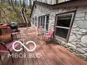 Stone house features a spacious deck, perfect for outdoor entertaining and relaxation in a wooded setting at 7018 Drum Dr, Nineveh, IN 46164
