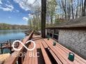 Waterfront home features a large deck overlooking the water, ideal for enjoying lake views and outdoor activities at 7018 Drum Dr, Nineveh, IN 46164