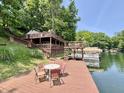 Enjoy this spacious wooden dock with seating, plus boat dock, perfect for lakeside relaxation and entertaining at 7018 Drum Dr, Nineveh, IN 46164