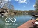 Picturesque waterfront view showcasing a tranquil lake, boat docks, and charming lakeside homes in a serene setting at 7018 Drum Dr, Nineveh, IN 46164