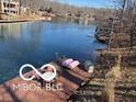 Quaint lake view and boat dock featuring lounge seating and lake access at 7018 Drum Dr, Nineveh, IN 46164