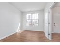 Inviting bedroom with light wood floors, a bright window, and a fresh, neutral paint scheme at 7164 Firestone Rd, Whitestown, IN 46052