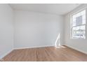 Bright bedroom featuring light wood floors, a large window, and fresh, neutral paint, perfect for relaxation at 7164 Firestone Rd, Whitestown, IN 46052