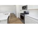 Modern kitchen with stainless steel appliances and white cabinetry at 7164 Firestone Rd, Whitestown, IN 46052