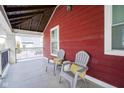 Covered porch with two gray chairs and pillows at 745 Laurel St, Indianapolis, IN 46203