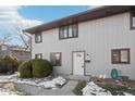 Two-story townhome with light gray siding, and a white door at 7906 Benjamin Dr, Indianapolis, IN 46226