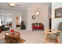 Spacious living room with comfortable seating, a fireplace and a view into a sunroom at 8042 Hazen Way, Indianapolis, IN 46216