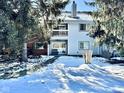 Condo building backyard with snowy landscape and trees at 8104 Glenwillow Ln # 208, Indianapolis, IN 46278