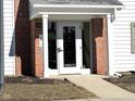 Close-up of the building's front door with red brick and white trim at 8104 Glenwillow Ln # 208, Indianapolis, IN 46278