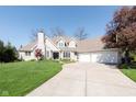 Charming two-story home with a well-manicured lawn, neutral color palette, and long driveway at 10295 Summerlin Way, Fishers, IN 46037