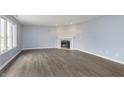 Spacious living room with a fireplace, large windows, and stylish wood-look floors at 116 Jasper Way, Anderson, IN 46012