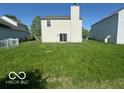 Spacious backyard with lawn, house, and a chimney at 11663 Congressional Ln, Indianapolis, IN 46235