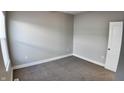 Simple bedroom with gray walls, neutral carpeting, and a window at 1401 N Pershing Ave, Indianapolis, IN 46222