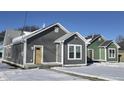 Three newly constructed homes with gray and green siding, snow-covered yards at 1401 N Pershing Ave, Indianapolis, IN 46222