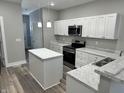 Modern kitchen with white cabinets and an island at 1407 N Pershing Ave, Indianapolis, IN 46222