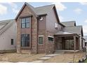 New two-story home featuring brick and cedar siding and black-trimmed windows at 17333 Ackerson Blvd, Westfield, IN 46074