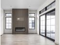 Modern living room featuring a linear fireplace and large windows at 17333 Ackerson Blvd, Westfield, IN 46074