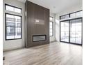 Living room with modern fireplace and patio access at 17333 Ackerson Blvd, Westfield, IN 46074