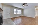 Hardwood floor living room with brick fireplace and access to other rooms at 1844 Averitt Rd, Greenwood, IN 46143