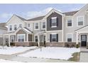 Two-story townhome with brick and siding exterior, snow-covered landscaping, and a walkway at 1965 Mildred Rd, Westfield, IN 46074