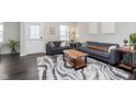 Spacious living room with dark hardwood floors, gray sofas, and a wood coffee table at 1965 Mildred Rd, Westfield, IN 46074