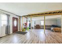 Living room with hardwood floors and exposed beams during remodel at 2003 S Bolton Ave, Indianapolis, IN 46203