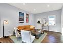 Bright living room with leather couch, wood coffee table, and hardwood floors at 2015 Columbia Ave, Indianapolis, IN 46202
