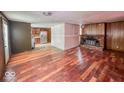Living room with hardwood floors and brick fireplace at 216 W 27Th St, Anderson, IN 46016