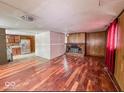 Living room with hardwood floors and brick fireplace at 216 W 27Th St, Anderson, IN 46016