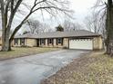 Ranch home with stone exterior, attached garage, and mature trees at 2526 Pleasant W Way, Carmel, IN 46280