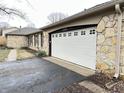 Attached garage with white door and stone exterior at 2526 Pleasant W Way, Carmel, IN 46280