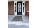 Black front door with a security screen and gray mat at 448 N Gray St, Indianapolis, IN 46201