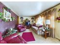 Bright living room with floral sofa and leather recliner at 4712 Southern Ave, Anderson, IN 46013