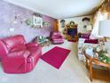 Spacious living room featuring a comfy leather recliner and floral couch at 4712 Southern Ave, Anderson, IN 46013