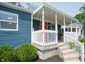 White porch with red door and curved railing at 50 N Edmondson Ave, Indianapolis, IN 46219