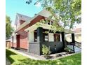Side view of a renovated two-story house with a red exterior at 52 N Mount St, Indianapolis, IN 46222